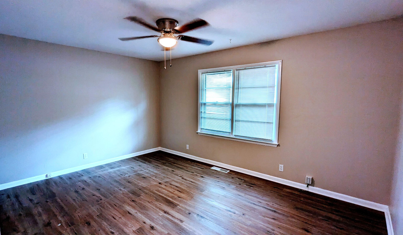 Undisclosed Address Raleigh, NC 27604 - Photo 10 of 32 an empty room with wooden floor and windows