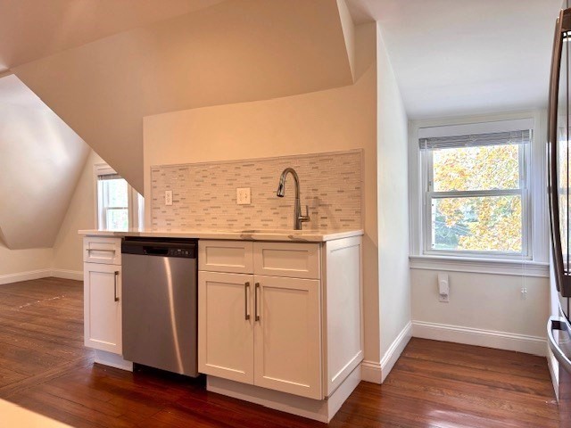 19-21 Bellevue Street, Unit 3 Waltham, MA 02453 - Photo 3 of 9 a view of kitchen with granite countertop cabinets and wooden floor