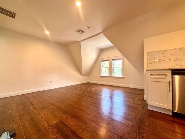 19-21 Bellevue Street, Unit 3 Waltham, MA 02453 - Photo 4 of 9 an empty room with wooden floor and windows