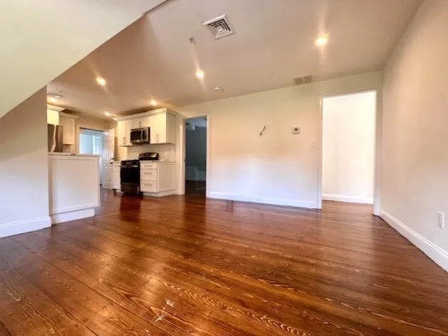 a view of kitchen with refrigerator and window