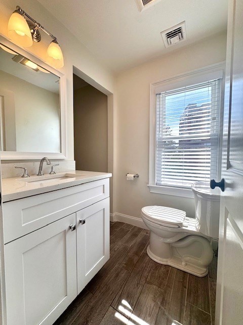 19-21 Bellevue Street, Unit 3 Waltham, MA 02453 - Photo 6 of 9 a bathroom with a granite countertop toilet a sink and a mirror