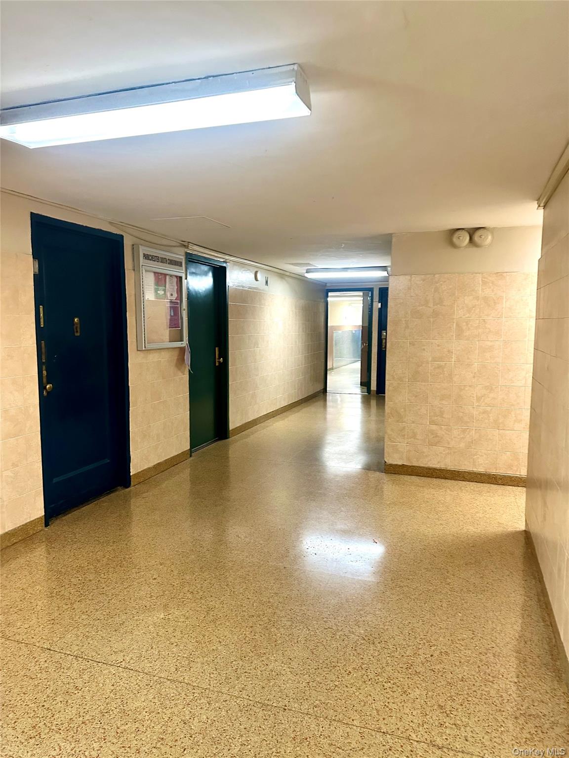 20 Metropolitan Ovl, Unit 11A Bronx, NY 10462 - Photo 14 of 16 Spare room featuring concrete block wall