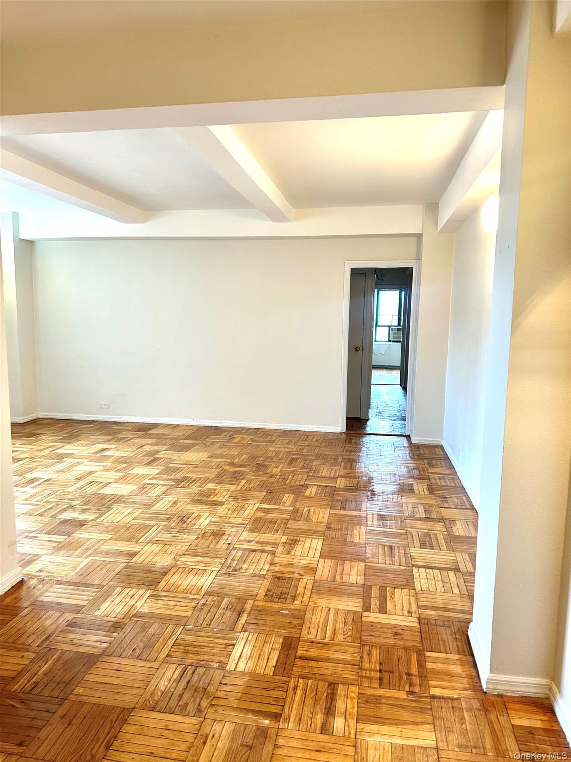 20 Metropolitan Ovl, Unit 11A Bronx, NY 10462 - Photo 2 of 16 Spare room with baseboards and beam ceiling