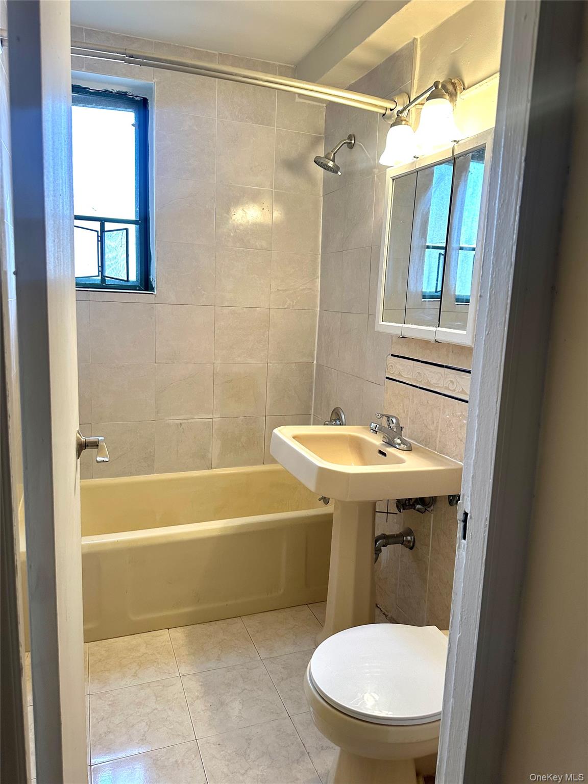 20 Metropolitan Ovl, Unit 11A Bronx, NY 10462 - Photo 6 of 16 Bathroom with shower combination and tile walls