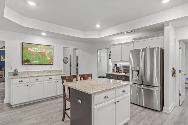 a kitchen with a refrigerator a sink a stove and wooden floor