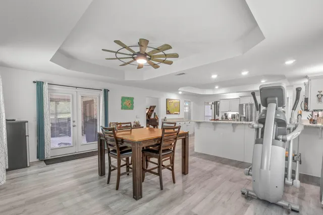 a view of a dining room with furniture and a chandelier