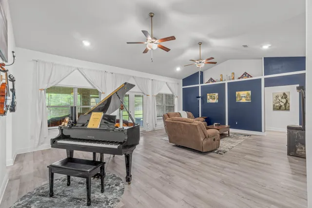 a living room with furniture and a wooden floor