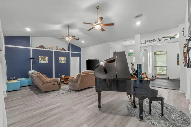 a living room with furniture and wooden floor