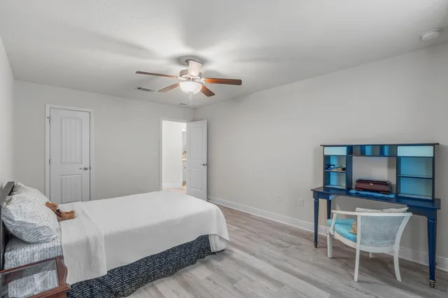 a bedroom with a bed window and a chair