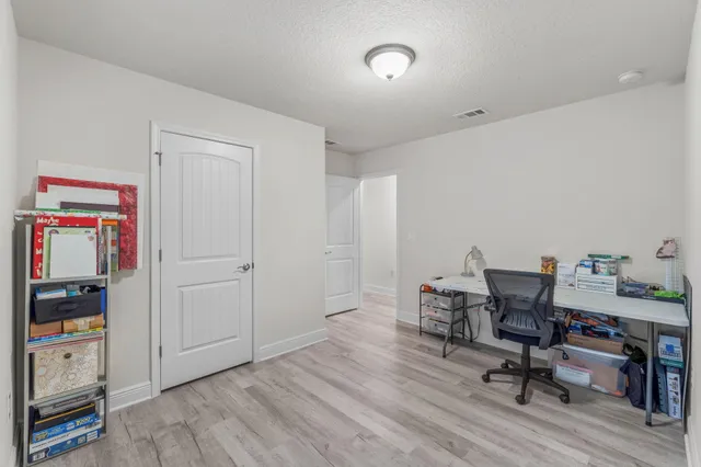 a view of a workspace with furniture and wooden floor