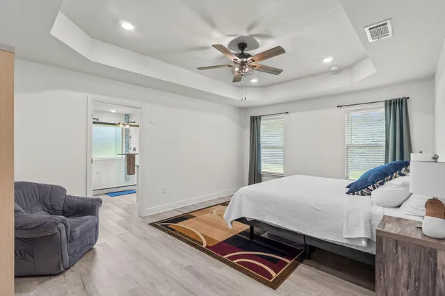 a bedroom with a bed and a chandelier