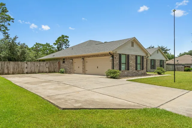 a front view of a house with yard and green space