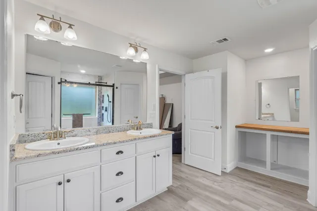 a bathroom with a double vanity sink mirror and double