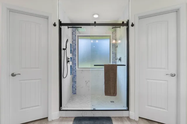 an empty room with wooden floor and mirror
