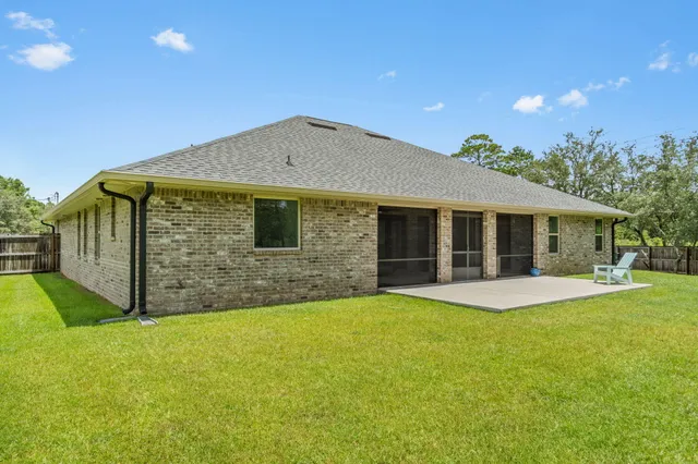 a front view of a house with yard and garage