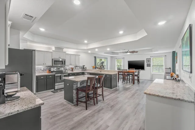 a kitchen with lots of counter top space and stainless steel appliances