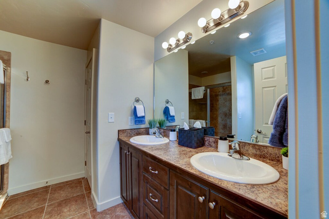 3853 South Red Valley Circle, Unit 22A1 Moab, UT 84532 - Photo 15 of 28 Full bath featuring double vanity, a stall shower, and light tile patterned flooring