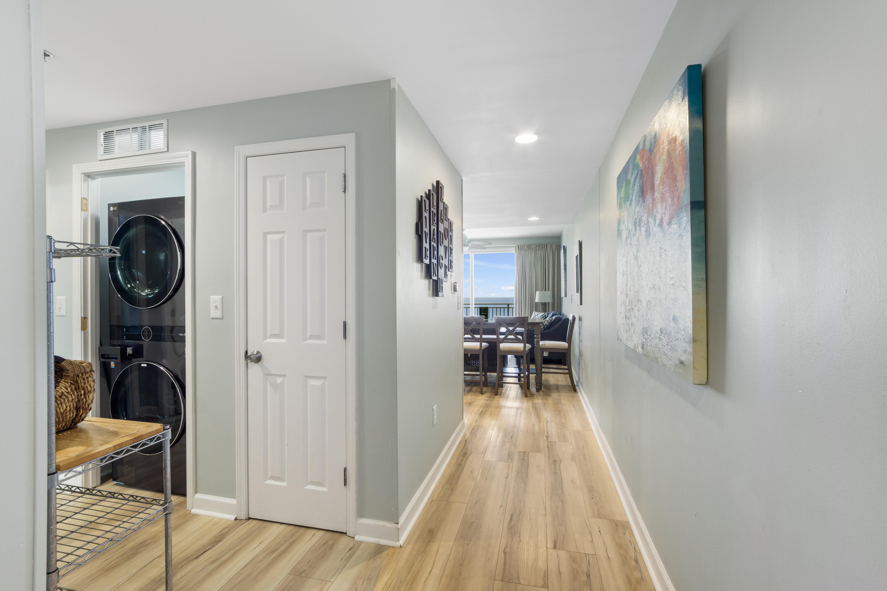17739 Front Beach Road, Unit 1902W Panama City Beach, FL 32413 - Photo 13 of 54 a view of a hallway with living room and furniture