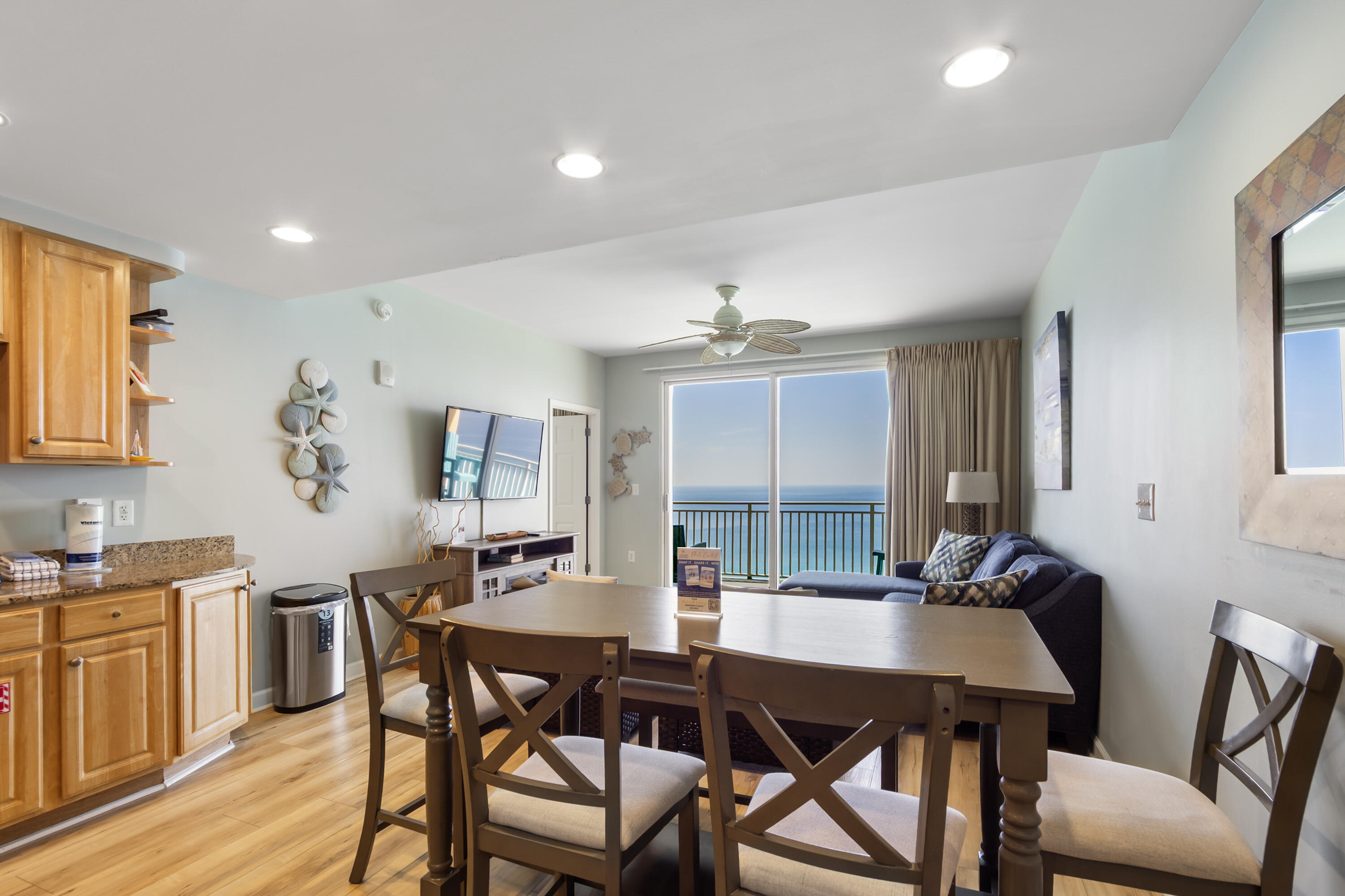 17739 Front Beach Road, Unit 1902W Panama City Beach, FL 32413 - Photo 16 of 54 a view of a dining room with furniture and wooden floor