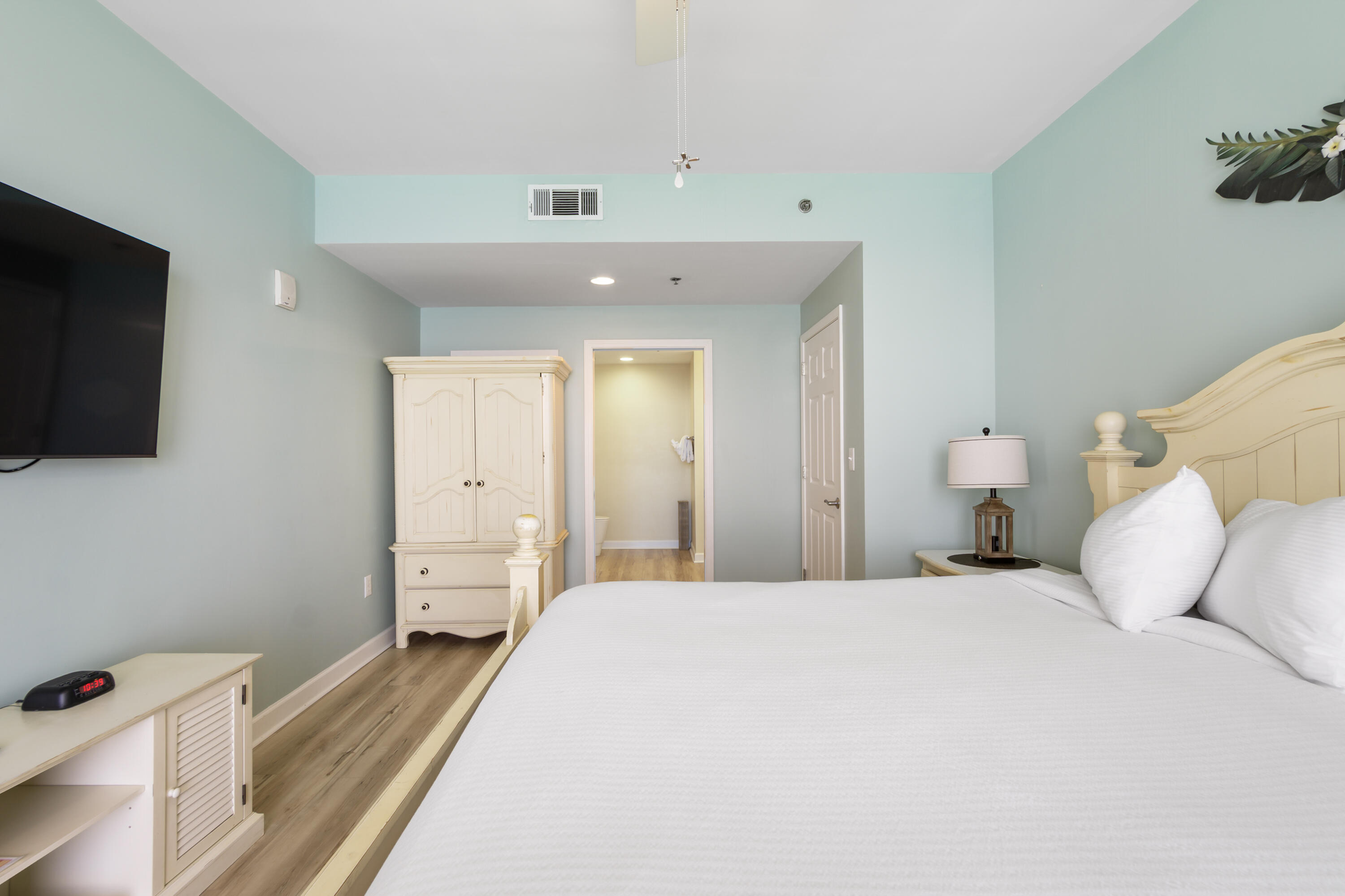17739 Front Beach Road, Unit 1902W Panama City Beach, FL 32413 - Photo 22 of 54 a bedroom with a bed and a flat tv screen on dresser