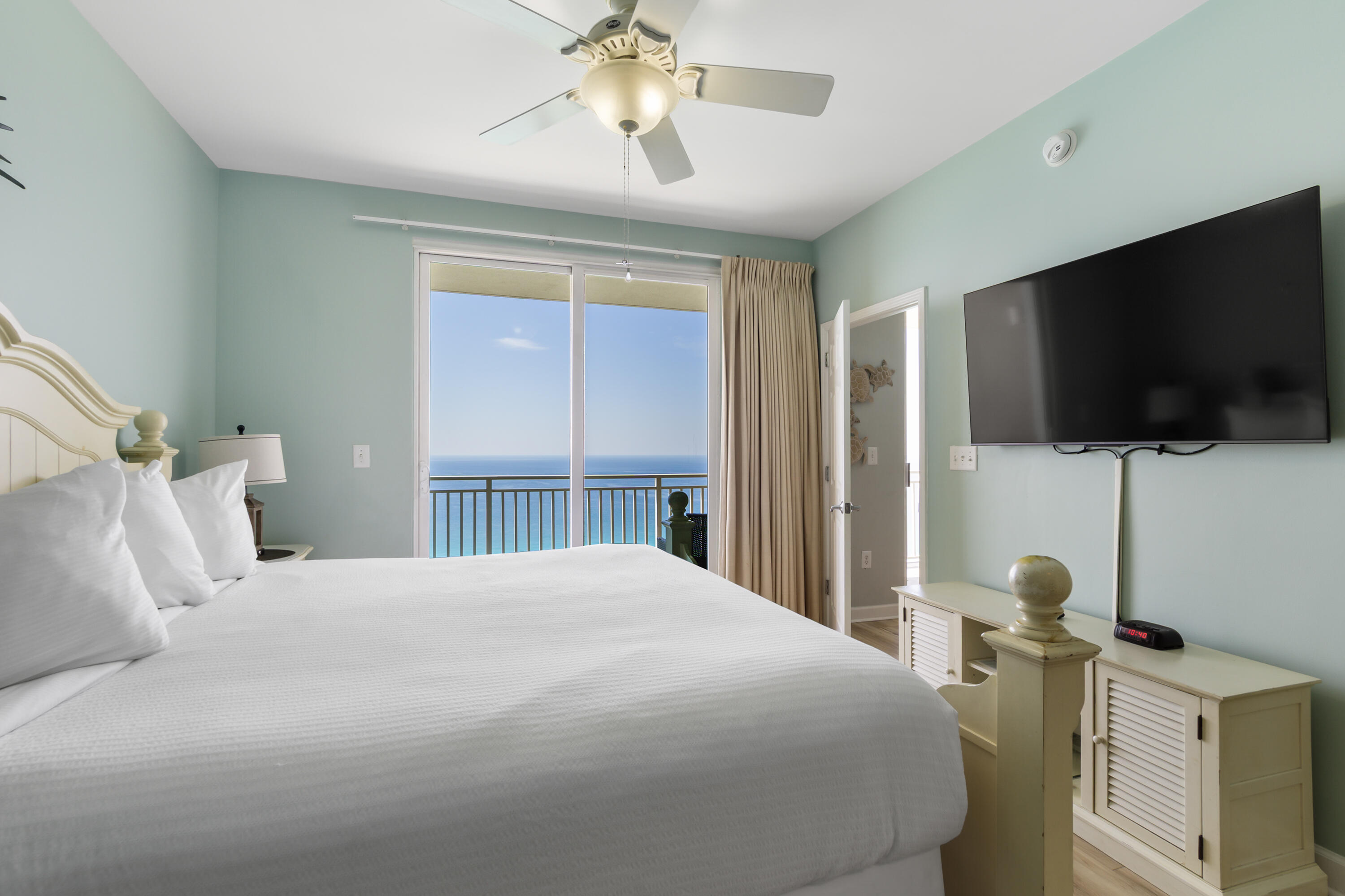 17739 Front Beach Road, Unit 1902W Panama City Beach, FL 32413 - Photo 23 of 54 a bedroom with a bed and a flat tv screen on the dresser