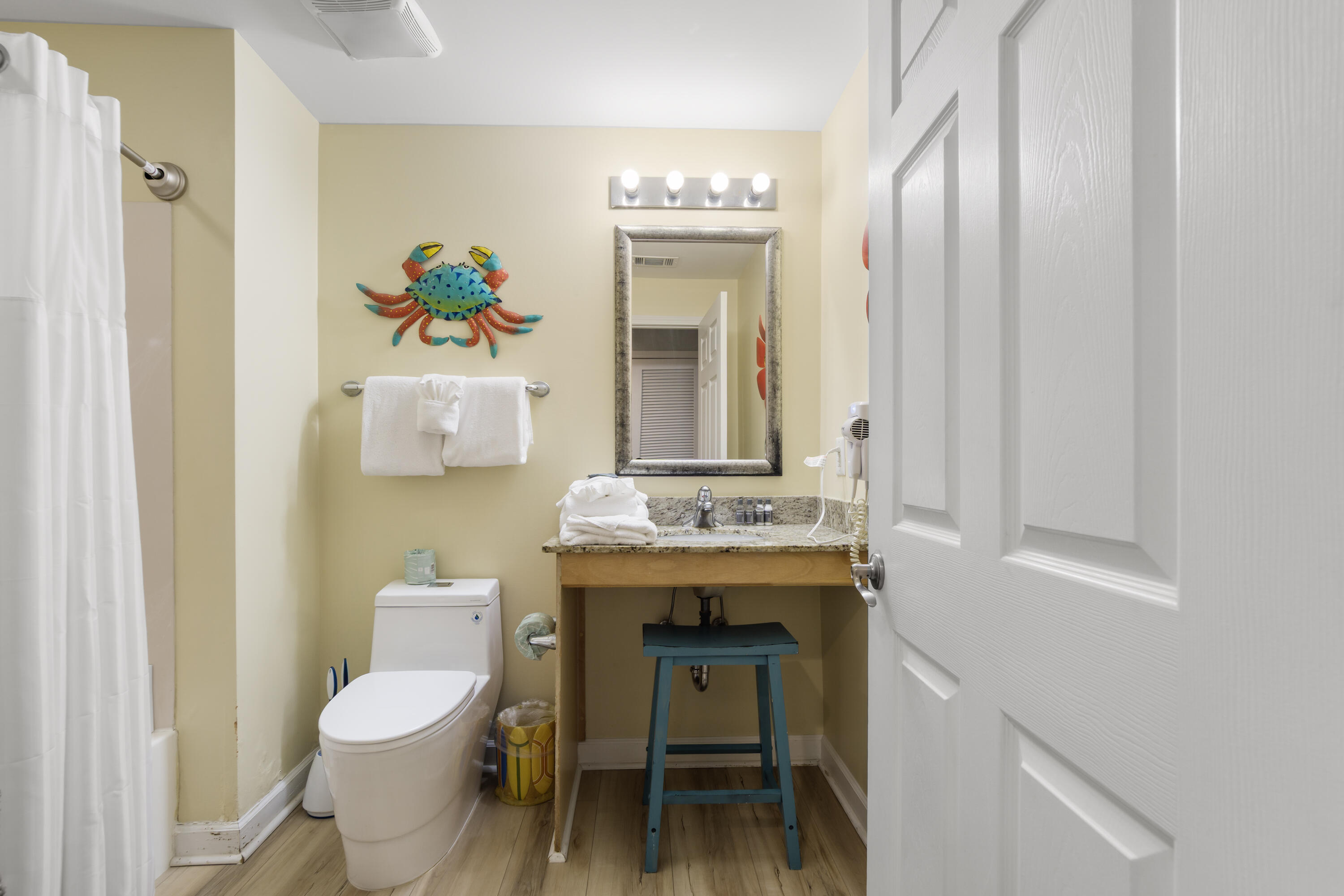 17739 Front Beach Road, Unit 1902W Panama City Beach, FL 32413 - Photo 28 of 54 a bathroom with a sink a toilet and a mirror