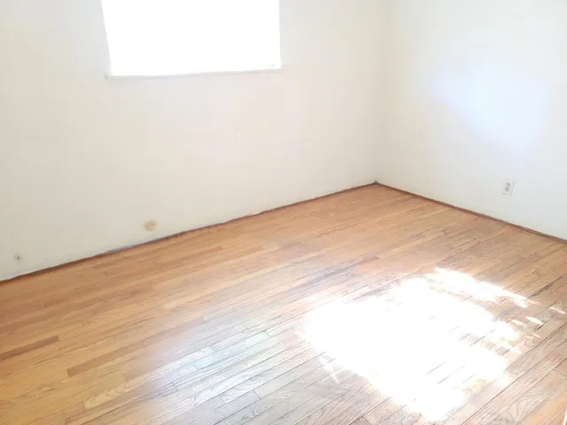an empty room with wooden floor