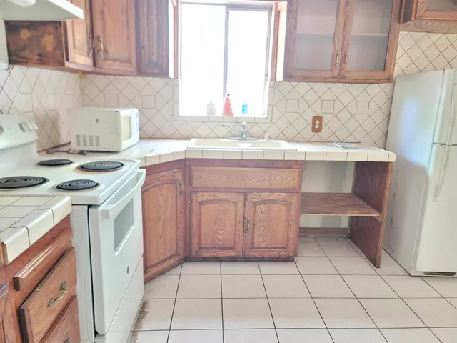 a kitchen with a sink stove and cabinets