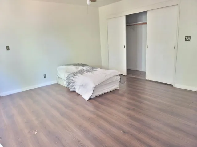 a view of bedroom with wooden floor