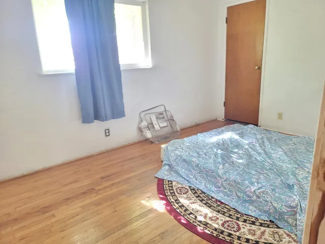 a bedroom with a bed and a window