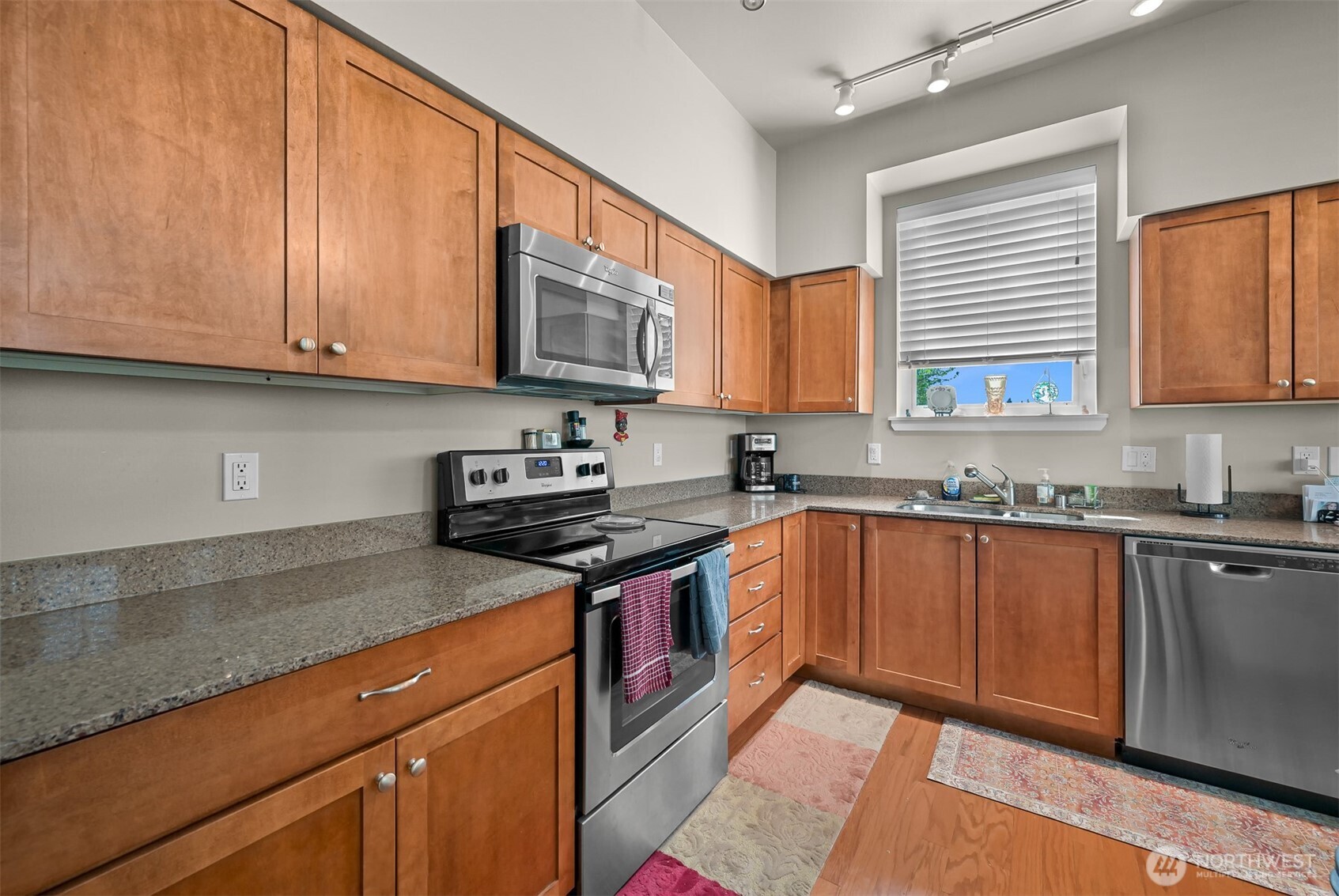 8844 Depot Road, Unit B101 Lynden, WA 98264 - Photo 9 of 30 a kitchen with stainless steel appliances granite countertop a sink stove and cabinets