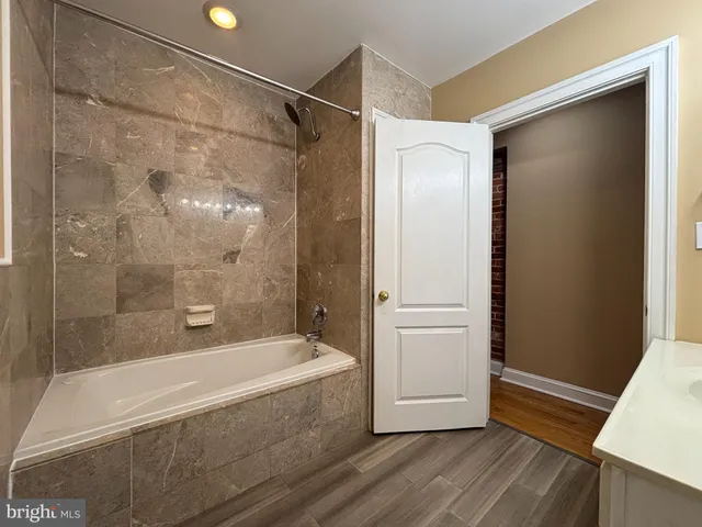 a bathroom with a bathtub and a shower