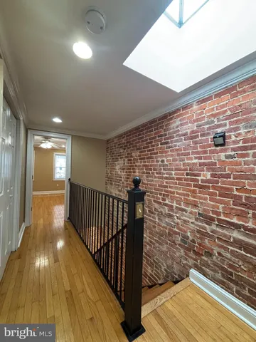 a view of hallway with wooden floor