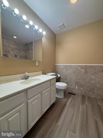 a bathroom with a double vanity sink and a toilet