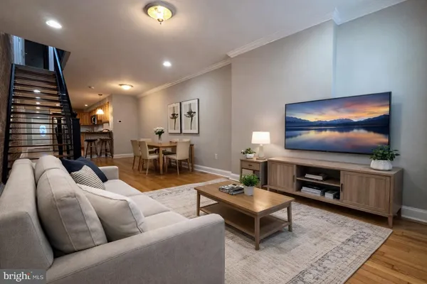a living room with furniture and a flat screen tv