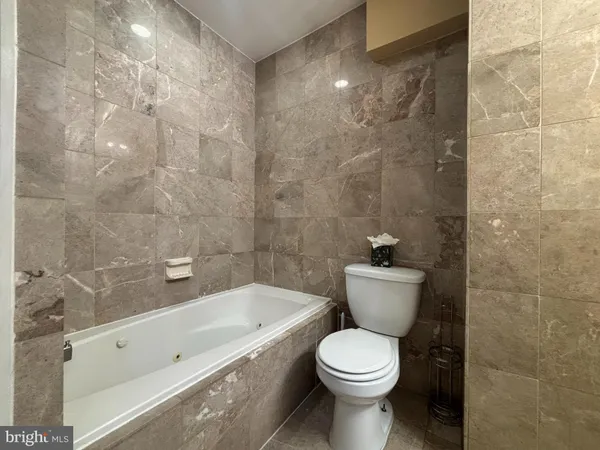 a bathroom with a toilet and a bathtub
