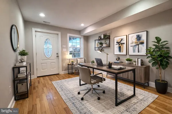 a view of a livingroom with furniture and a workspace
