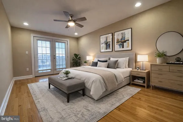 a bedroom with a large bed and a chandelier
