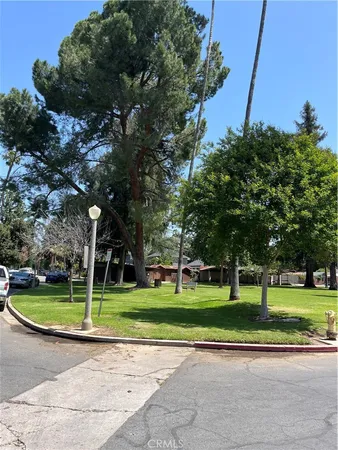a front view of a building with trees