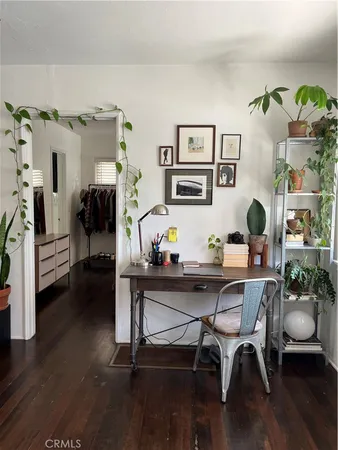 a view of a workspace with furniture and wooden floor