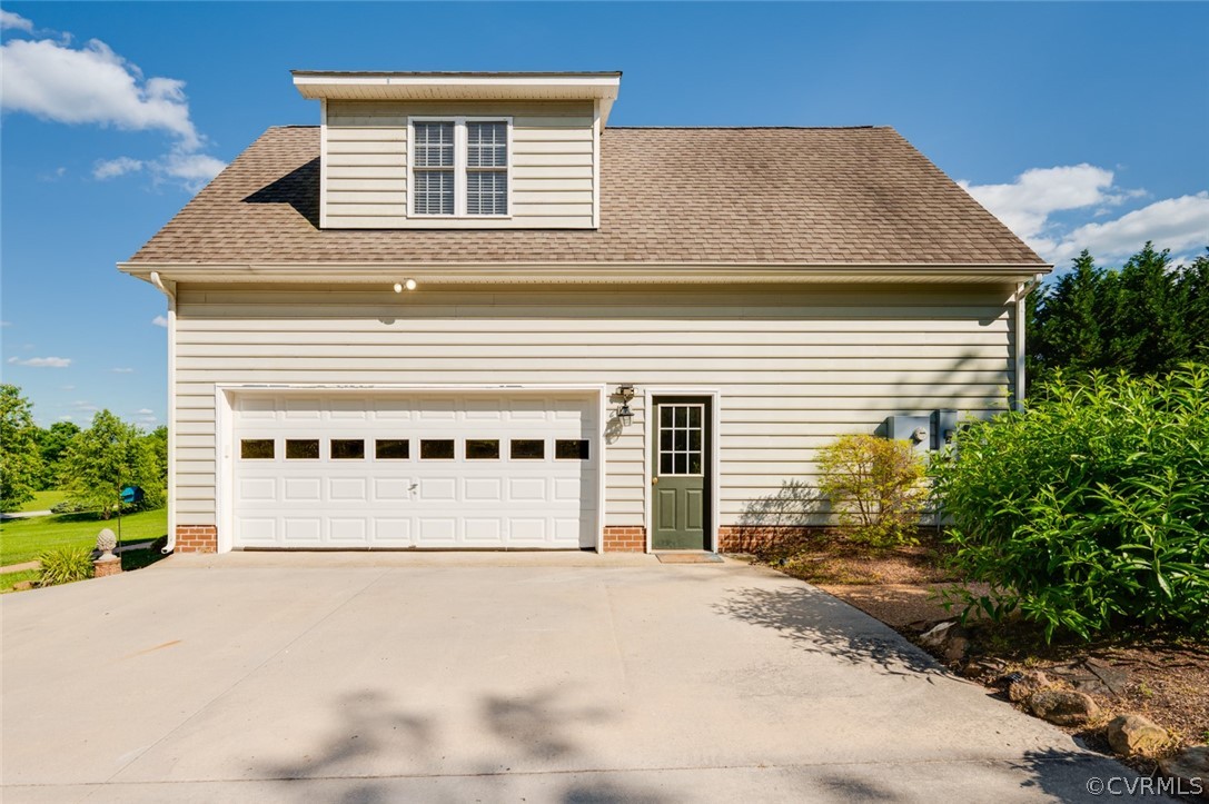 134 Gates Pointe Drive Rice, VA 23966 - Photo 18 of 20 a front view of a house with a yard and garage