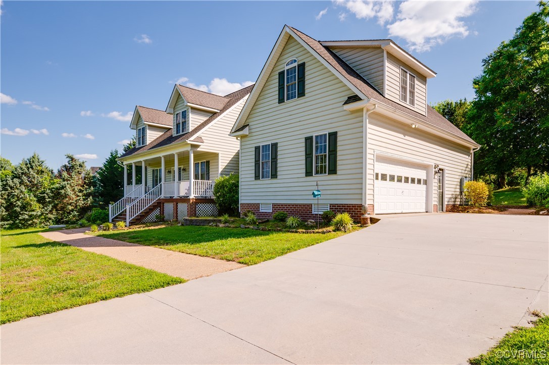 134 Gates Pointe Drive Rice, VA 23966 - Photo 2 of 20 a front view of a house with a yard and garage