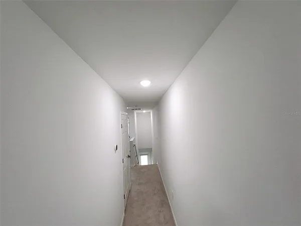 a view of a hallway with a door