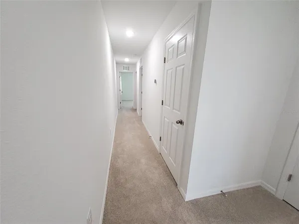 an empty room with a empty space and windows