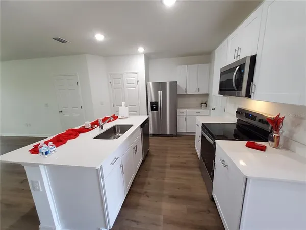 a kitchen with a sink and refrigerator