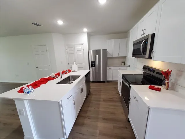 a kitchen with a sink and refrigerator