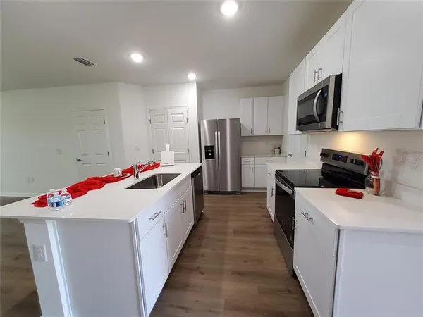 a utility room with wooden floor washer and dryer