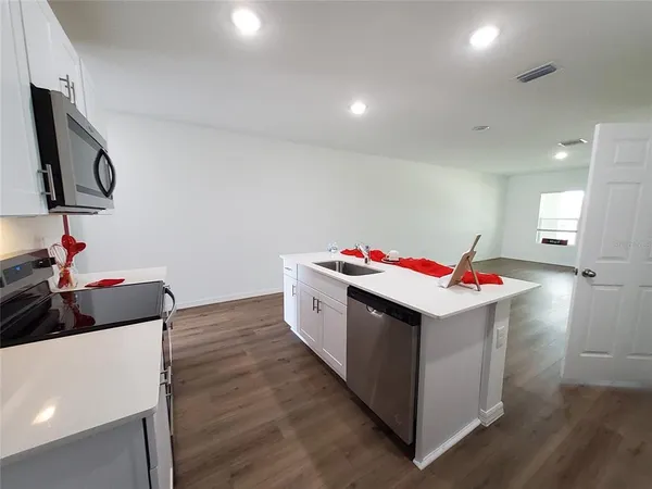 a room with wooden floors and white walls