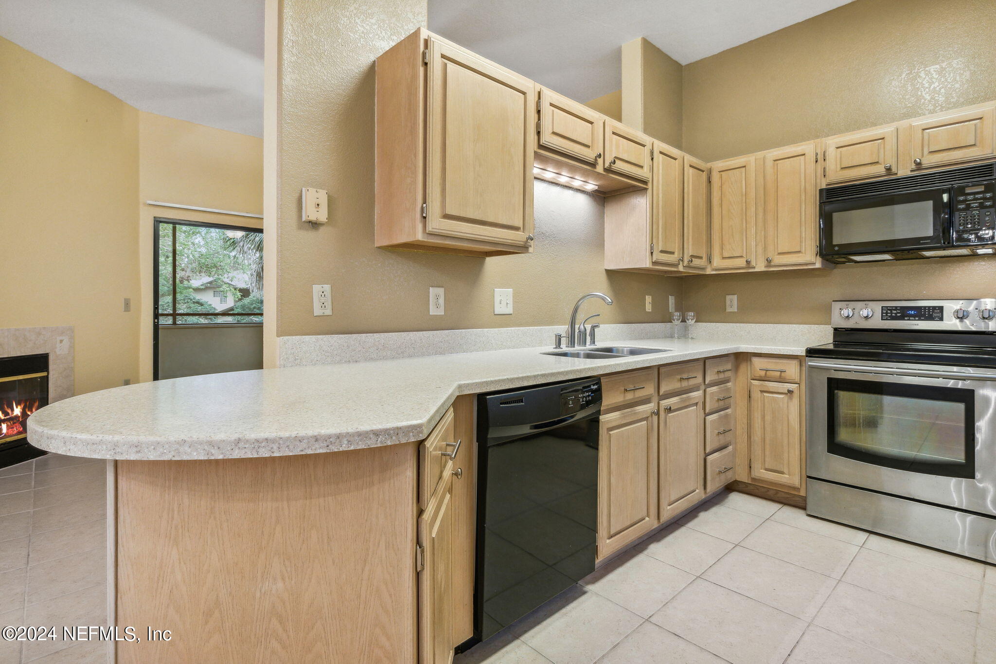 a kitchen with stainless steel appliances granite countertop a sink stove and microwave