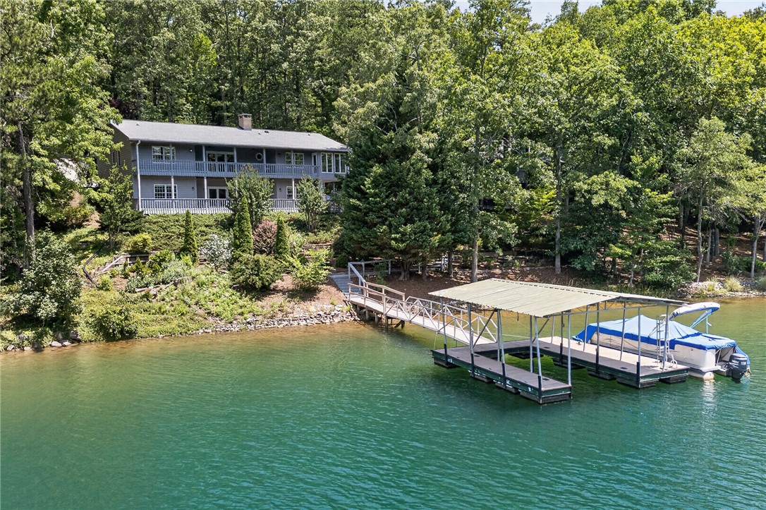 9 Lookout Lane Salem, SC 29676 - Photo 35 of 46 A spacious home nestled amidst lush greenery offers serene lake views and private boat dockage.